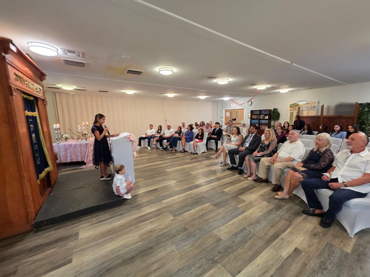 Family and friends seated for a bat mitzvah celebration at Chabad of Venice