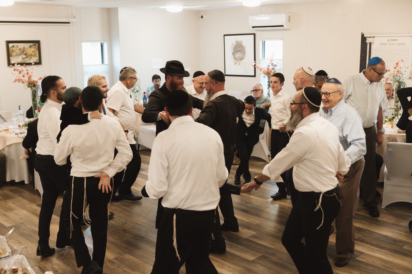 Men dancing in circles at the wedding celebration