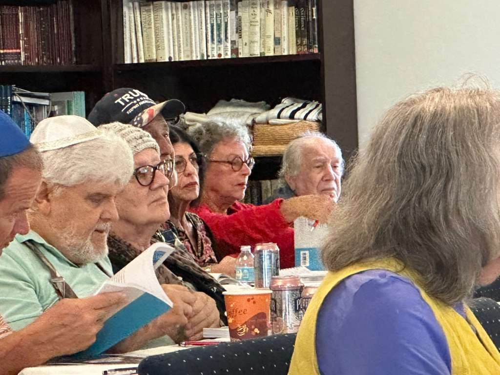 Adult students at a Chabad of Venice JLI class, following the lesson in their course books