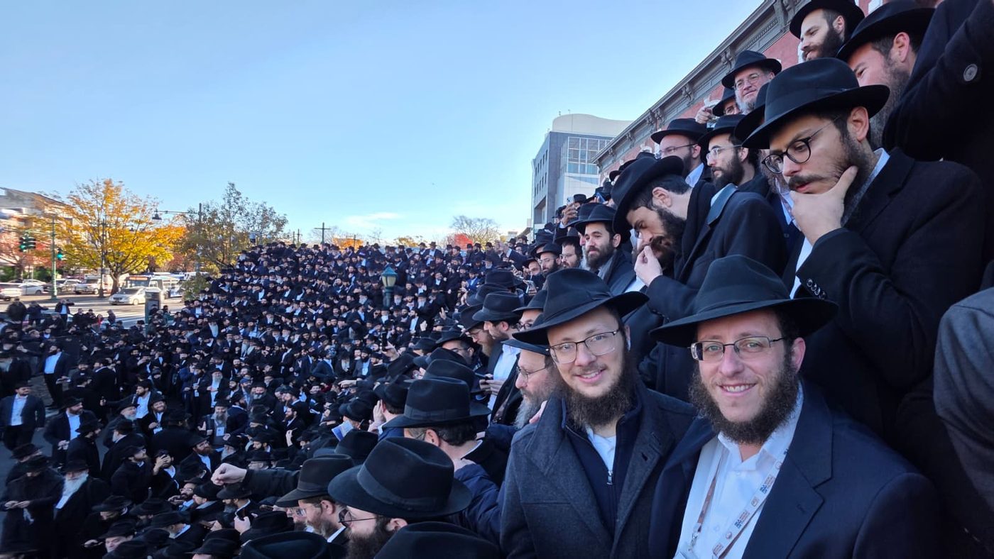 Rabbis packed shoulder to shoulder as the annual class photo assembles outside 770