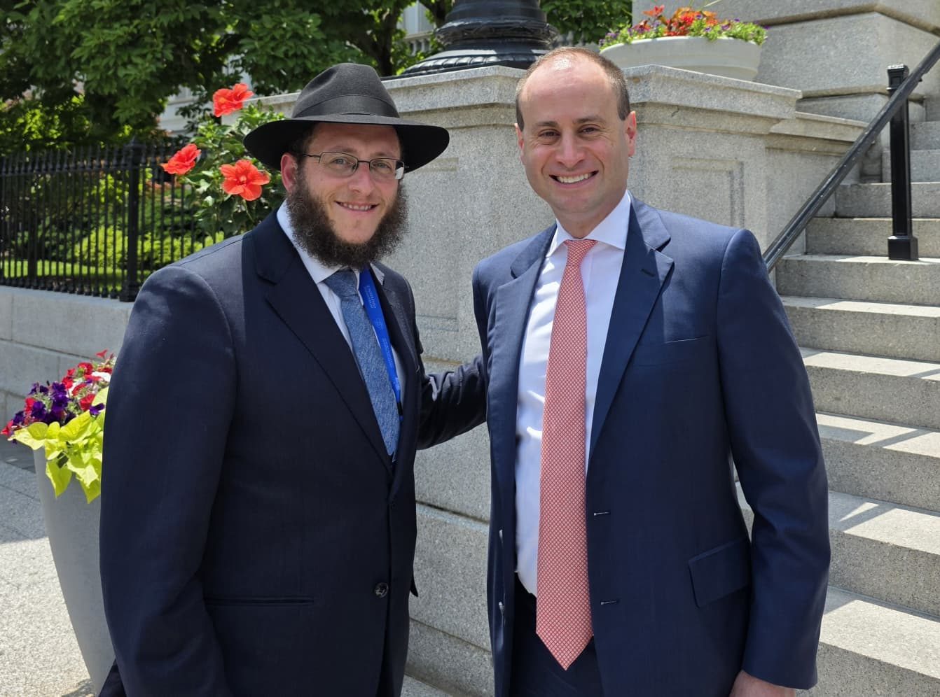 Rabbi Sholom Schmerling with Will Scharf, Assistant to the President, outside the West Wing