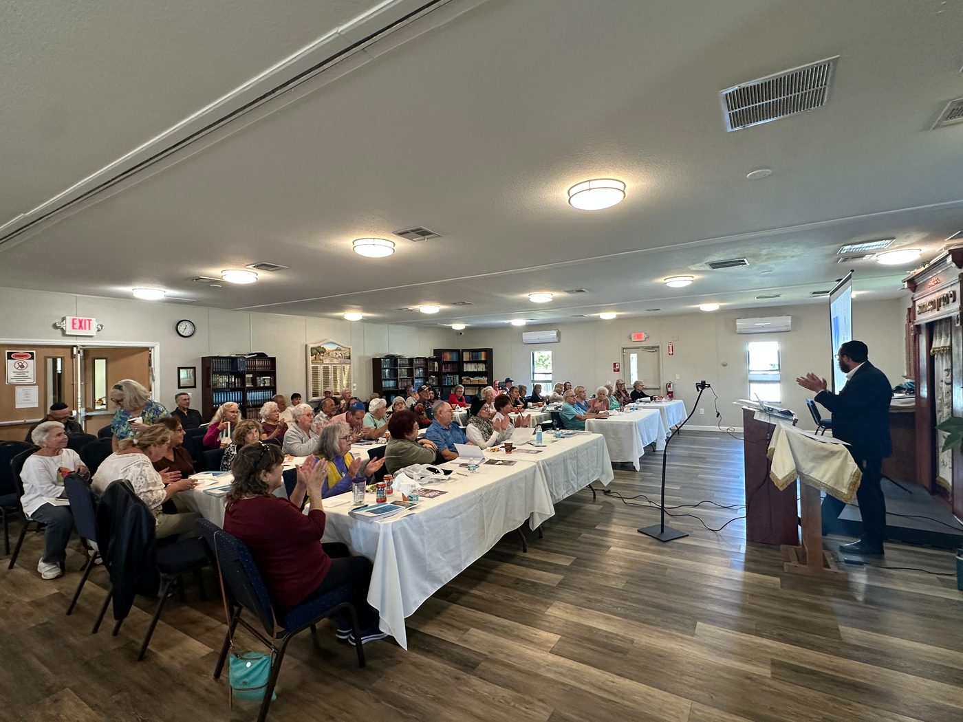 A Chabad of Venice class in session, tables full of students following along in their books