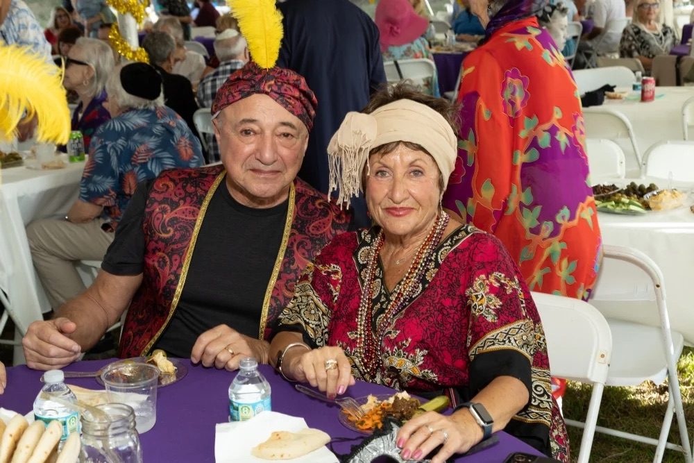 Two guests in elaborate Persian costume at a Purim in Persia table