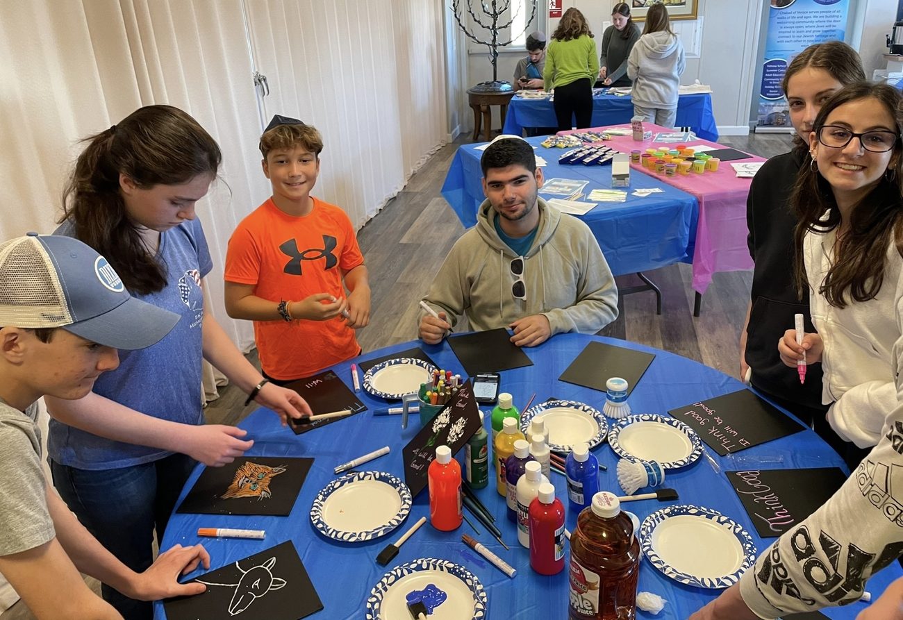 Teens socializing around the table at a CTeen event